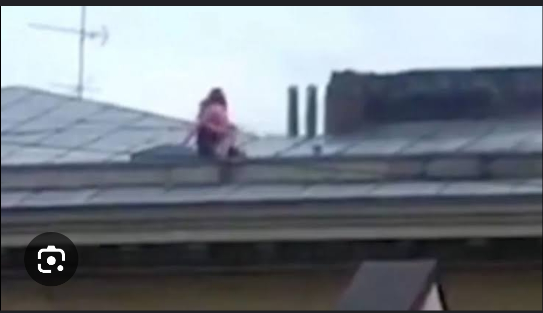 Raunchy couple risk their lives to have done this on the rooftop public on a sloped rooftop of four-storey building