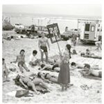 A woman warns beach goers that their clothing choices are going to send them to hell, 1980s.