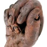 What may initially appear to be a carved wooden hand is, in fact, a close-up view of Old Croghan Man, a remarkably preserved 2,300-year-old Iron Age bog body.