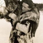 The legendary Norwegian explorer, Leonhard Seppala, holds his lead dog, Togo.